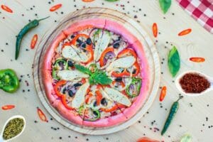 a colorful sliced pizza