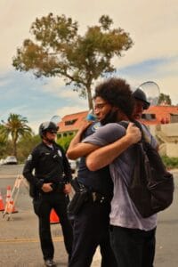 man in black t shirt carrying black backpack